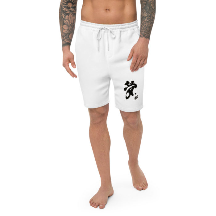 image of the lower half of a male from his torso down. He has his arms to the side with tatoos on both. he is wearing white shorts with the Japanese Calligraphy "Dream" he is bare foot and waling towards you