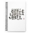 A white notebook with Japanese Calligraphy, the Calligraphy is the "Dojo" Kun (rules) It is black spiral bound